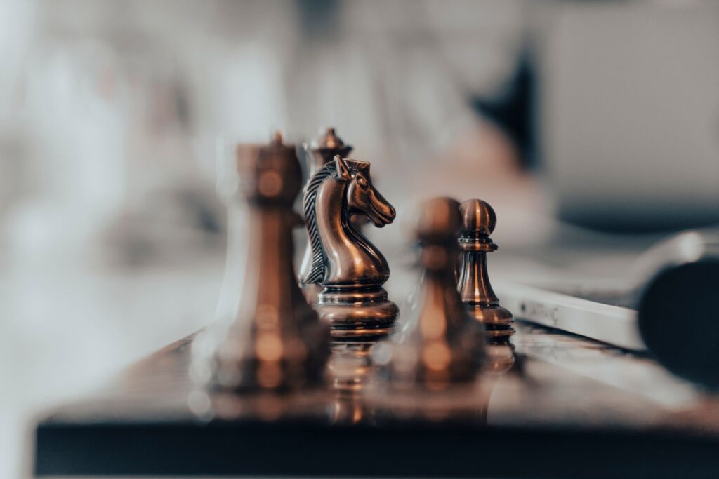 A detailed close-up of chess pieces on a board, highlighting the knight in warm tones.