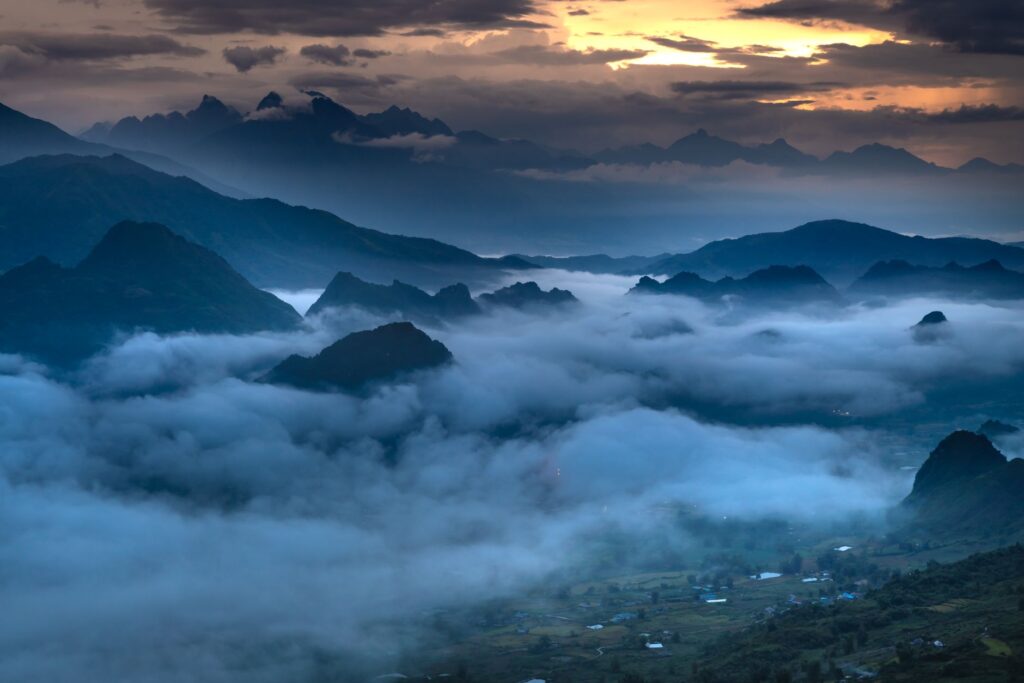 Breathtaking sunrise over foggy mountains, showcasing a dramatic sky and serene landscape, an image for Does God Exist? The Case for a Higher Power