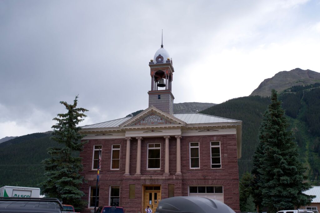 Silverton City Hall against mountain backdrop, an iconic landmark with architectural charm, an image for Western Democracy: Can a Muslim Be a Loyal Citizen