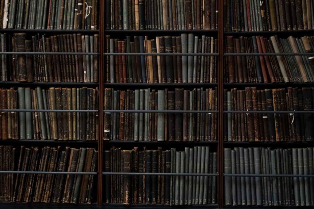 A close-up of vintage books on library shelves in London, showcasing an abundance of literary history, an image for Specific Problems in the Sources: Why I Left