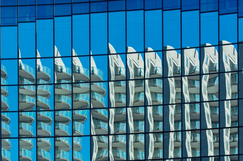 Abstract reflection of a modern building in a glass facade in Voorburg, Netherlands, an image for Psychological Projection: Is God Just a Projection of Human Psychology