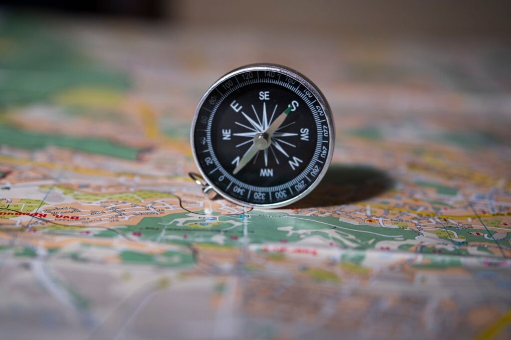 Black compass on detailed map symbolizing navigation and exploration, an image for Can You Ground Ethics Without God