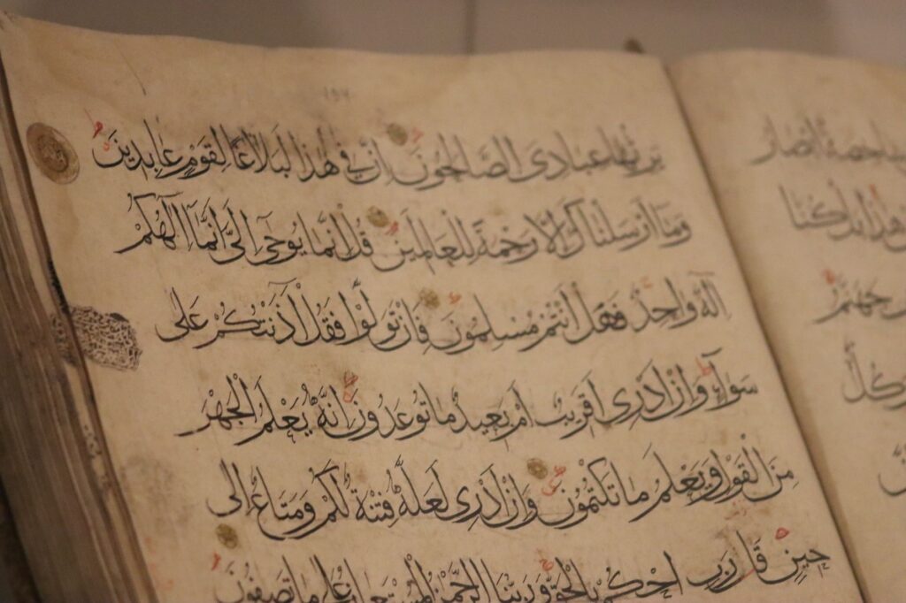 A detailed view of ancient book pages showcasing intricate Arabic calligraphy, an image for The Hadith Kill Him Who Changes His Religion: A Direct Response