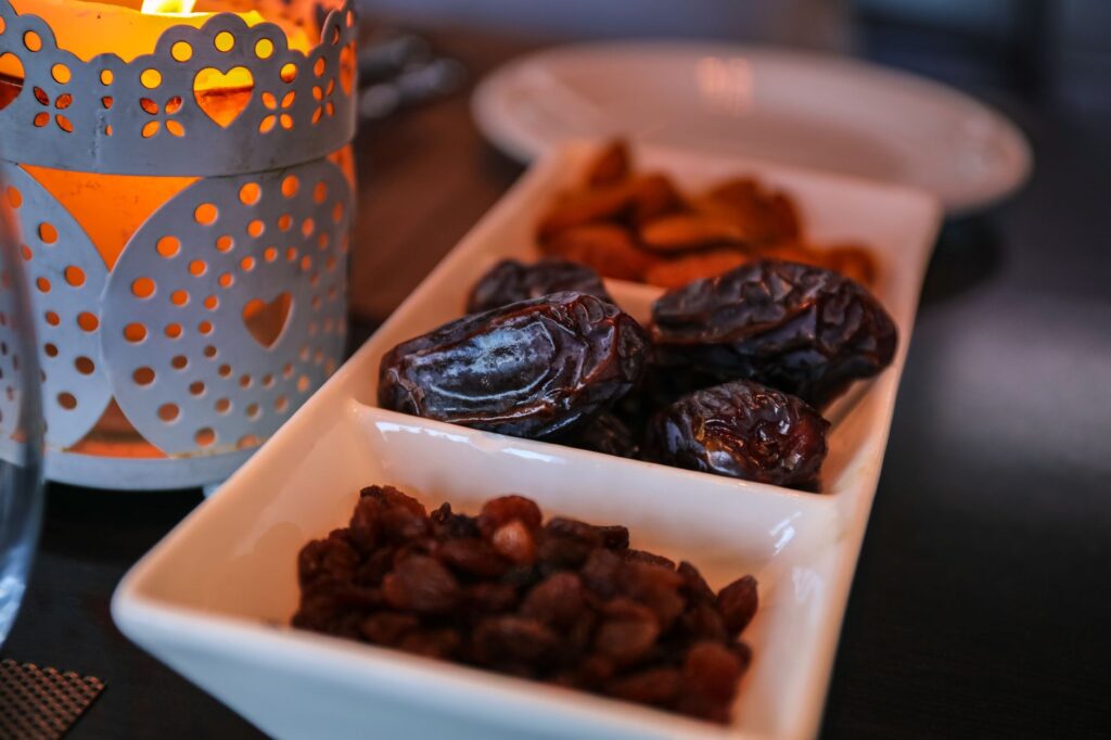Close-up of dried dates and lantern symbolizing Ramadan traditions. Ideal for festive themes, an image for Ramadan Fasting: What Is It For? Starvation on a Schedule