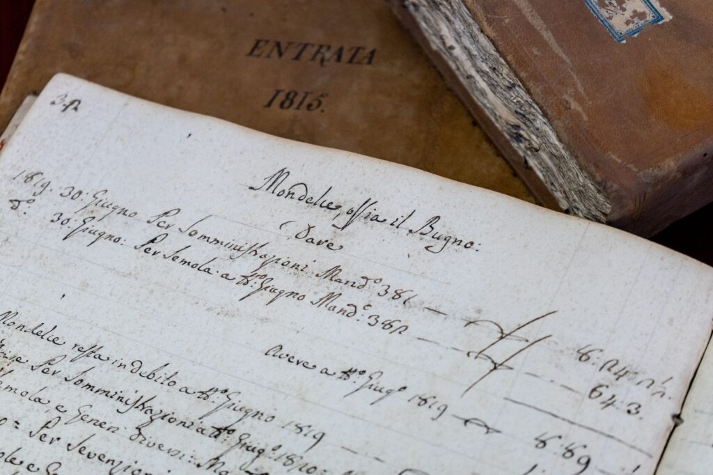 Detailed close-up of 19th-century handwritten documents and antique books, an image for Hadith Reliability: How Reliable Is Hadith Science