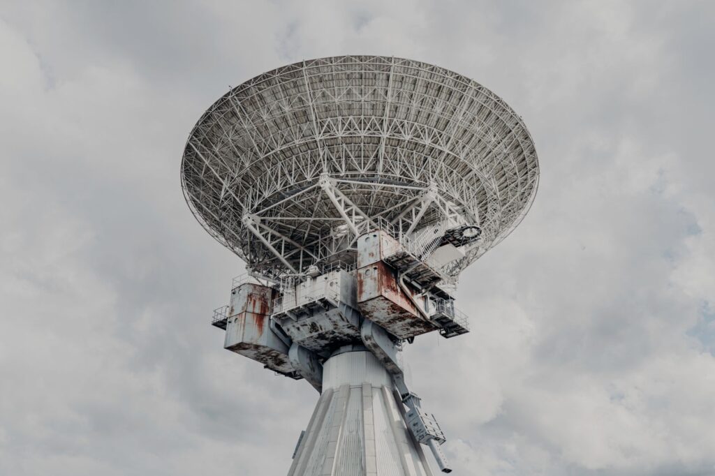Close-up of a large radio telescope against a cloudy sky, an image for Does God Communicate With Humanity