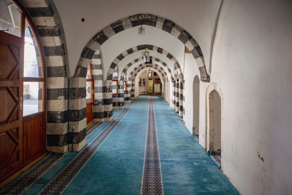 Explore the historic Ottoman-style archway corridor in Çermik, Diyarbakır, an image for The Good Muslim Paradox