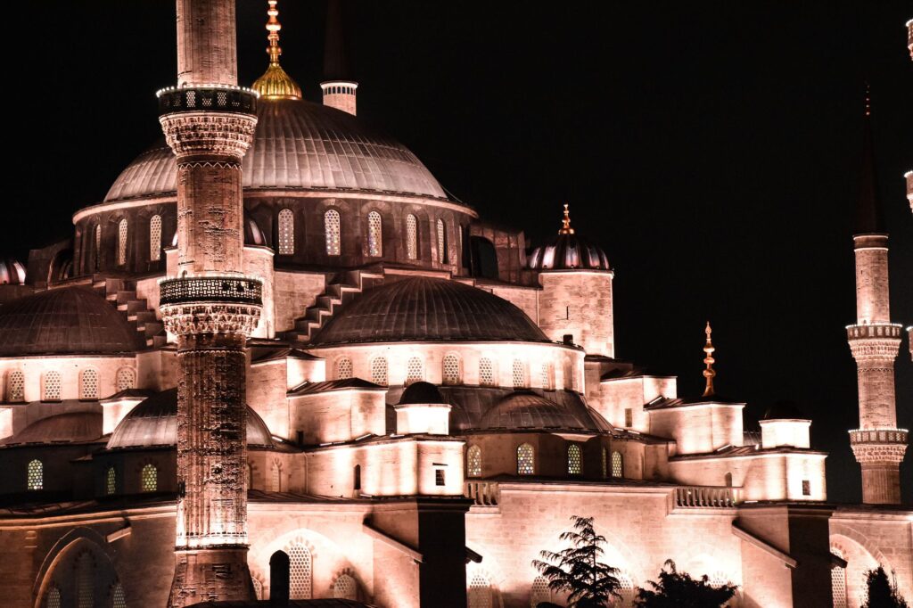 A captivating night view of the Blue Mosque in Istanbul, showcasing its stunning architecture and illuminated domes.