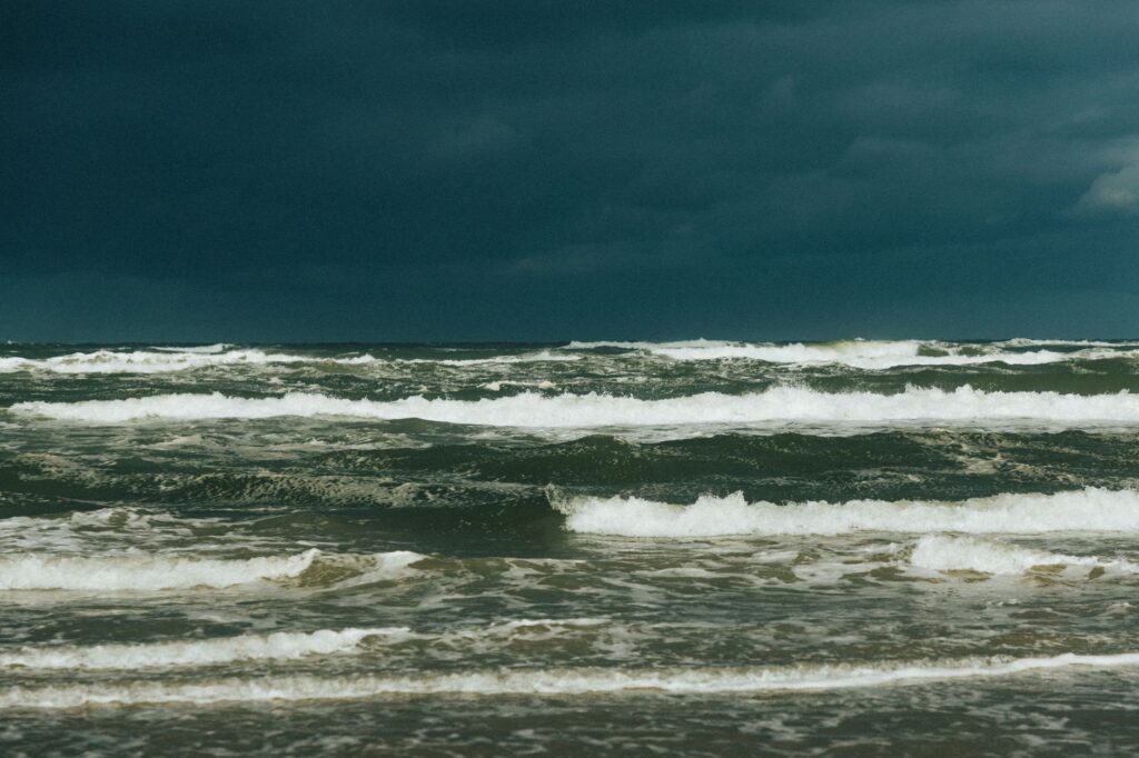 Captivating view of a stormy sea under dark clouds, showcasing powerful ocean waves.
