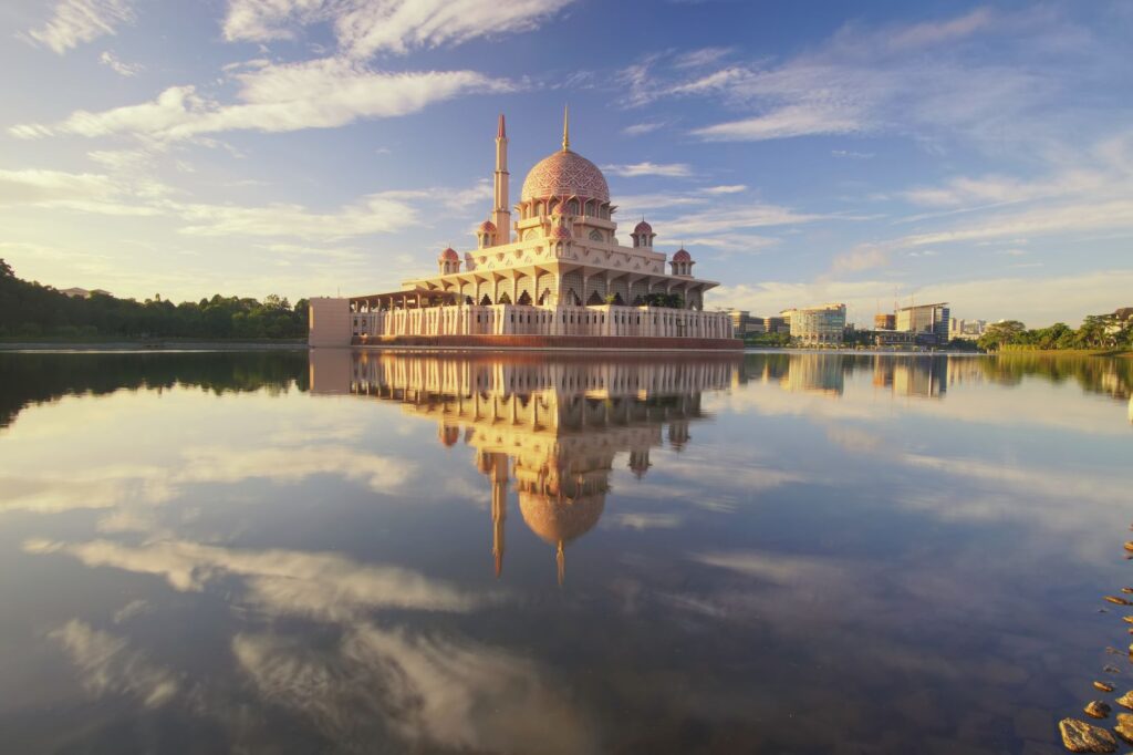 Beautiful scene of Putra Mosque reflecting on calm lake waters under a vibrant morning sky, an image for Built on Fear? Is Islam Just a System of Control