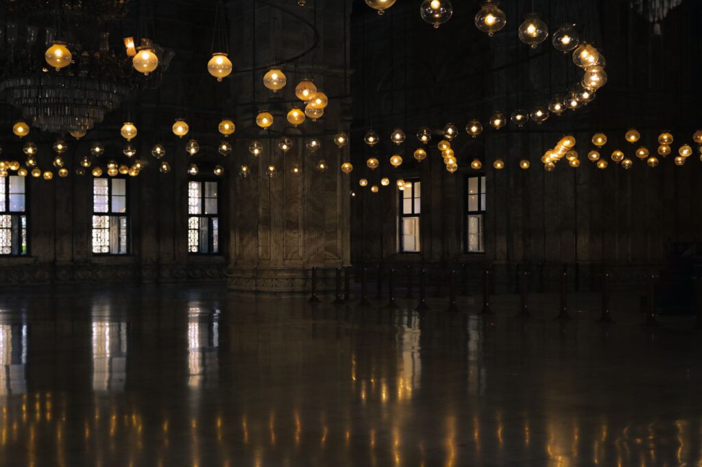 Elegant interior shot of Cairo mosque with stunning chandeliers and reflections, an image for Islam, Not Christianity: Why Choose Islam Over Another Religion