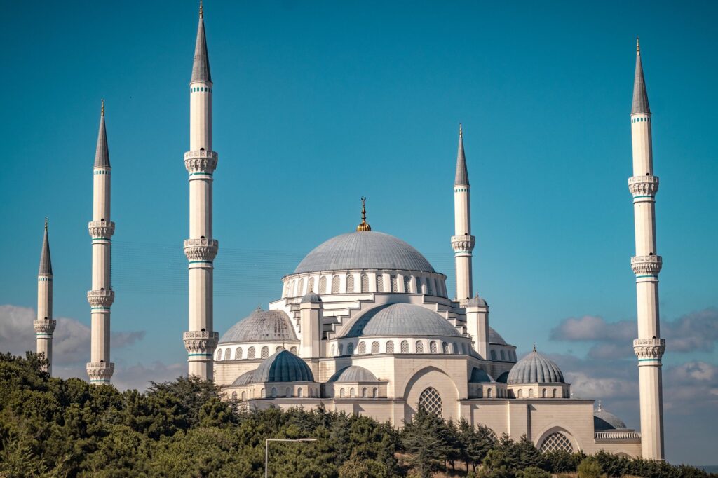 A beautiful exterior view of a large mosque with minarets against a clear blue sky, an image for Is Islam a Cult? The Comparison Examined and Rejected