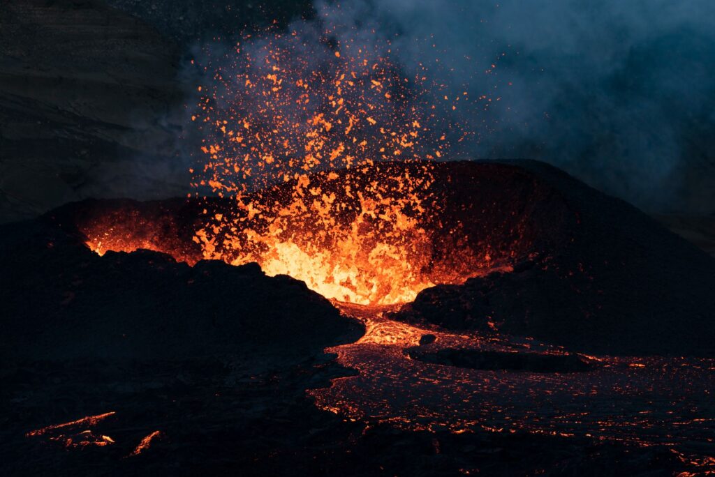Dramatic scene of lava erupting from an Icelandic volcano amid dark terrain, an image for The Anger Is Real — And It Deserves an Answer