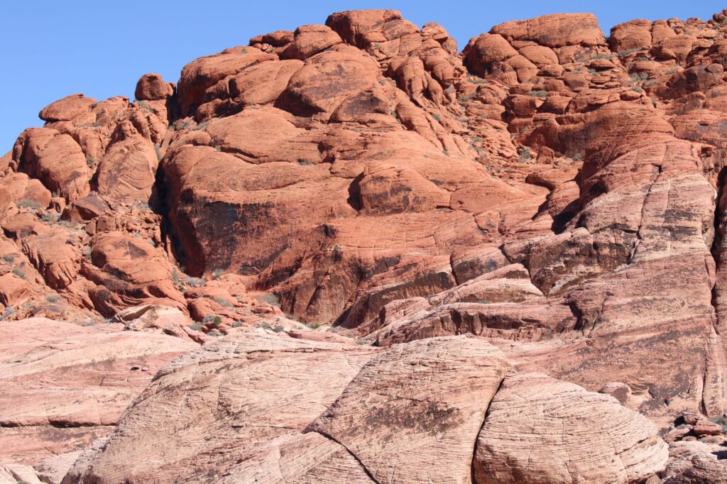 Capture of stunning red rock formations under a clear blue sky, showcasing natural desert beauty.