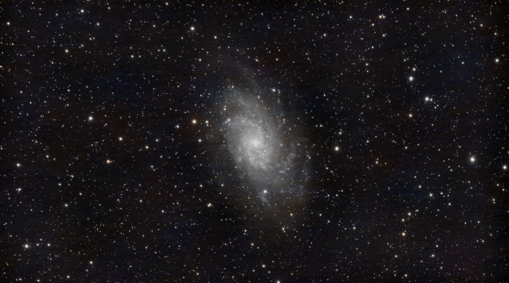 A mesmerizing image of a spiral galaxy surrounded by countless stars in the night sky.
