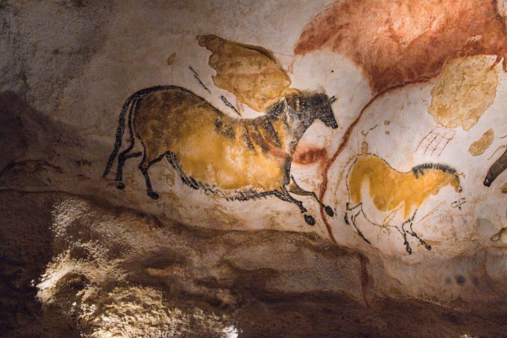 Historic Lascaux cave paintings depicting prehistoric horses in France, an image for Why Do Humans Believe in God at All