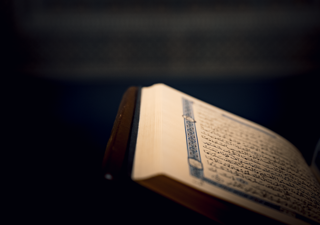 Close-up of a Quran page with intricate Arabic script, an image for The Quran as Literary Argument