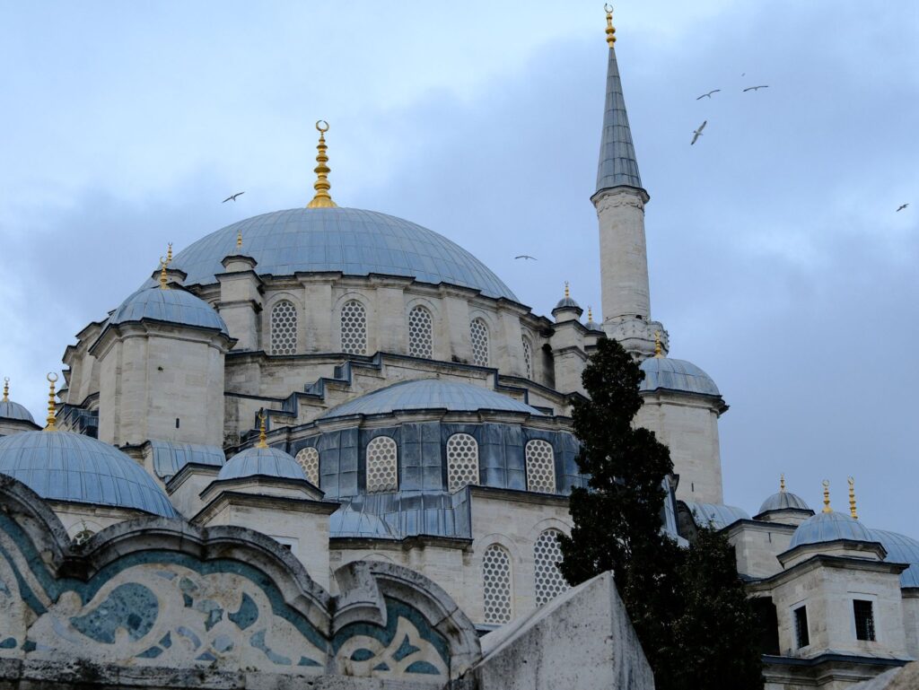 Elegant view of an Ottoman mosque dome in Istanbul, Türkiye, under a cloudy sky, an image for Apostasy, Political History and Islamic Law