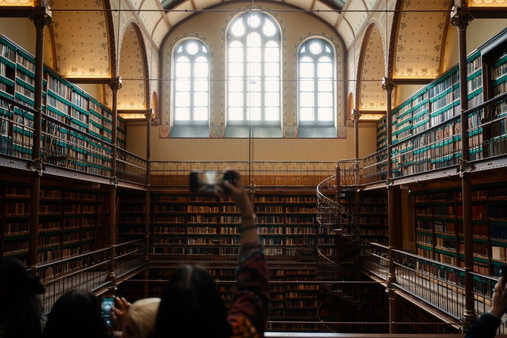 Stunning view of a historic library with ornate architecture and bookshelves reaching multiple stories.