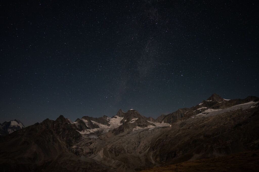 Captivating view of starry sky over the Zermatt mountains in Wallis, Switzerland at night.