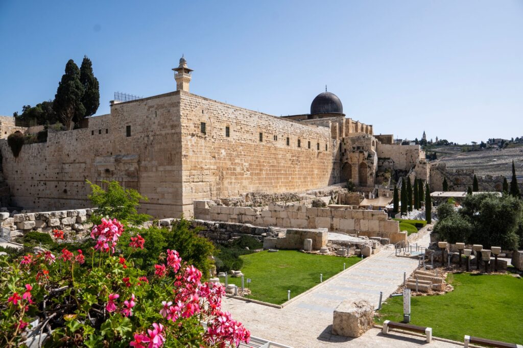 Scenic view of historical wall and lush greenery in Jerusalem's Old City, an image for Crucifixion: What Quran 4:157 Claims and What History Can Show
