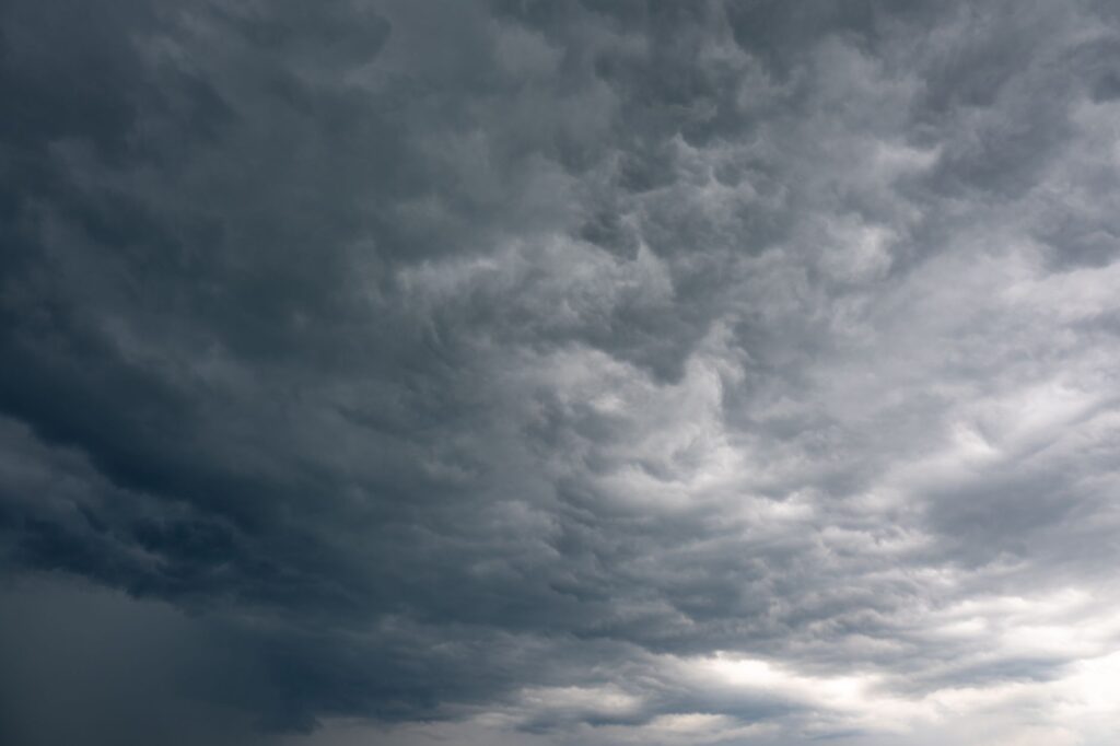 Moody dark clouds forming over Garešnica, Croatia creating a dramatic sky scene, an image for The Problem of Evil: If God Is Good, Why Is There Suffering