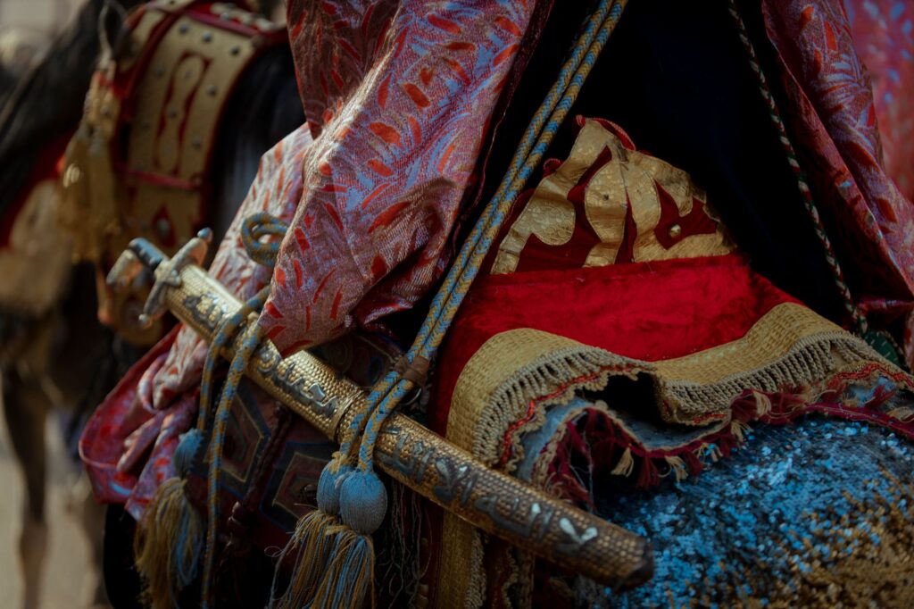 Close-up of an ornate traditional saddle with decorative fabric and a sheathed sword, an image for Muhammad and Warfare: If He Was a Prophet, Why the Sword