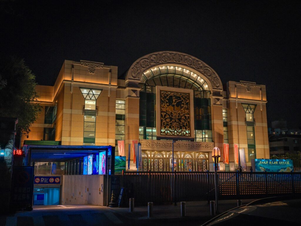 A beautifully lit building with decorative facade captured at night showcasing intricate design and bright lighting.