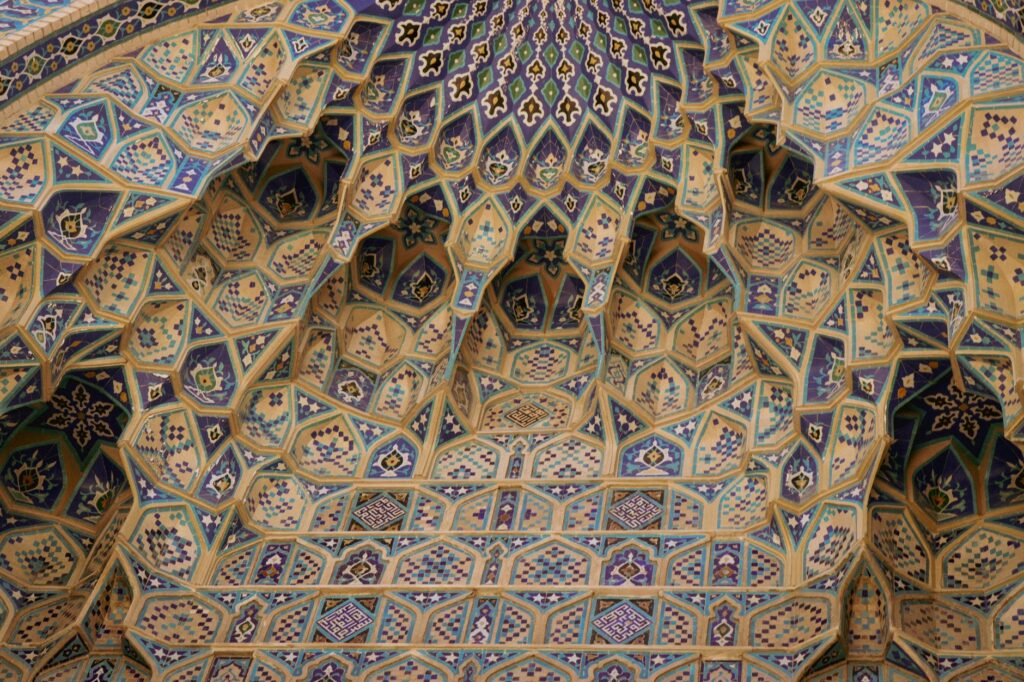 Detailed geometric patterns on an Islamic mosque dome showcasing Middle Eastern craftsmanship.