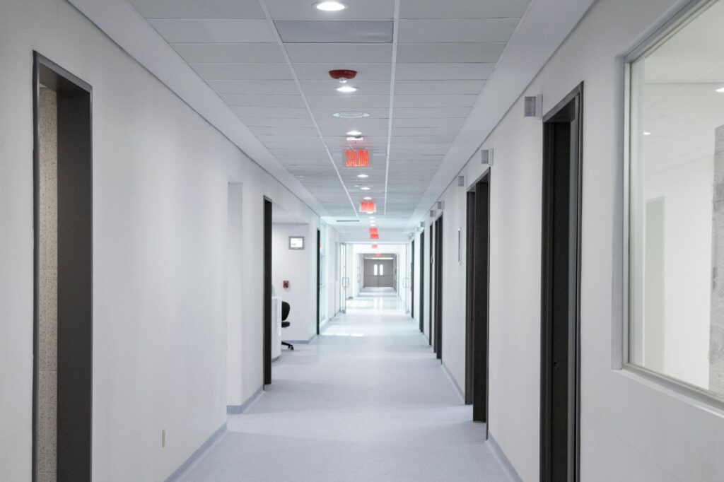 White-walled hospital corridor with modern design and bright overhead lighting, an image for Problem of Evil Response: Answering the Strongest Objection