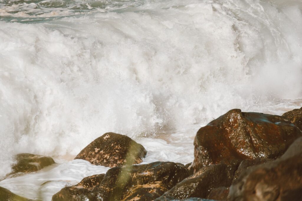 Powerful ocean waves crashing on rocky coastline with foamy surf creating a dramatic seascape.