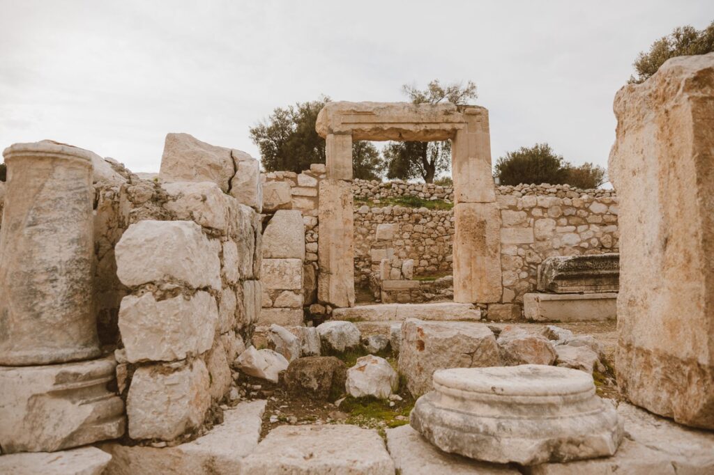 Explore ancient stone ruins featuring columns and a portal in a historic, timeless setting.