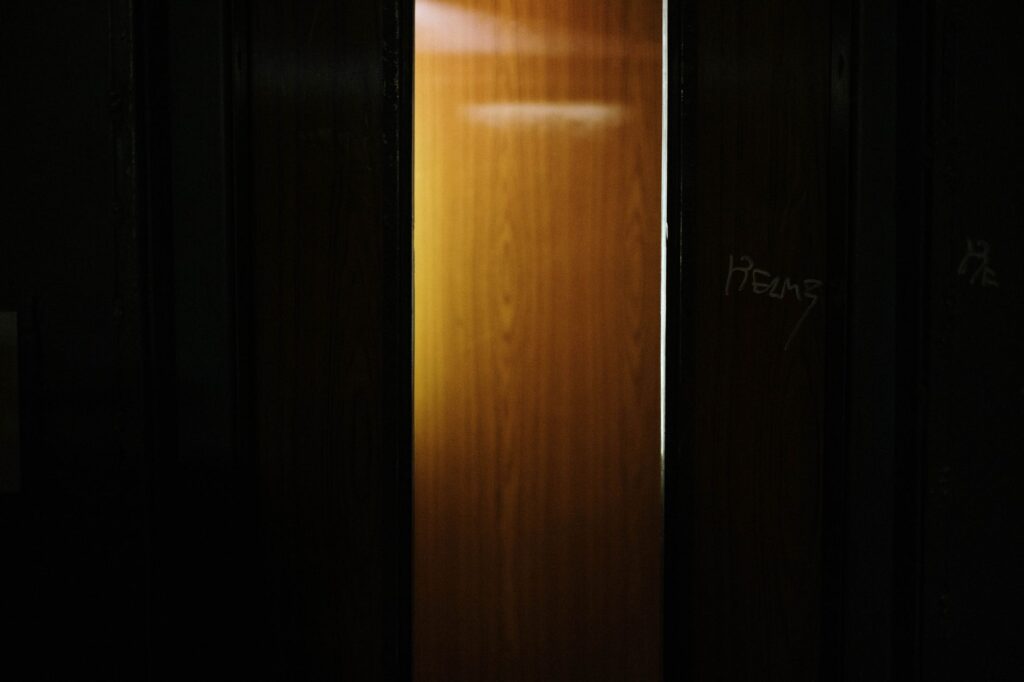 A partially open wooden door revealing light shining through a dark interior, an image for Muslims Leave Islam How? The Inner Journey