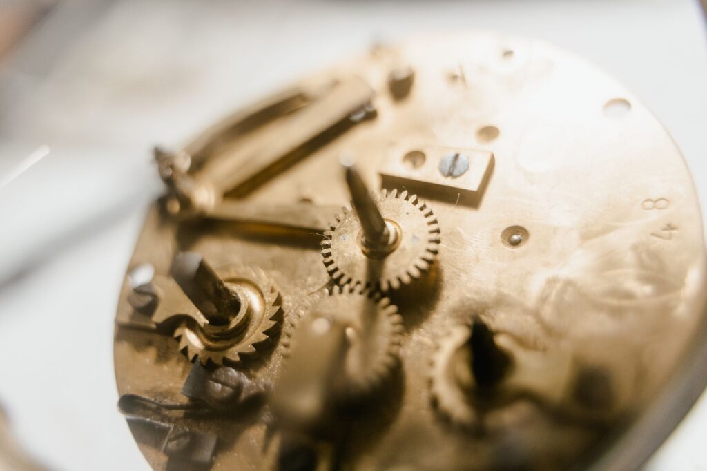 Detailed view of a vintage clockwork mechanism showcasing intricate gears and metallic components, an image for God, Personal or Deist? A Person or Just a First Cause