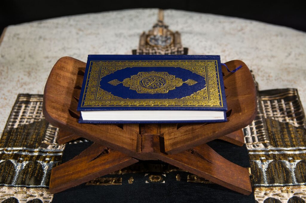 Close-up of the Quran on a wooden stand, symbolizing Islamic spirituality, an image for Quran Contradictions: How to Test an Alleged Contradiction