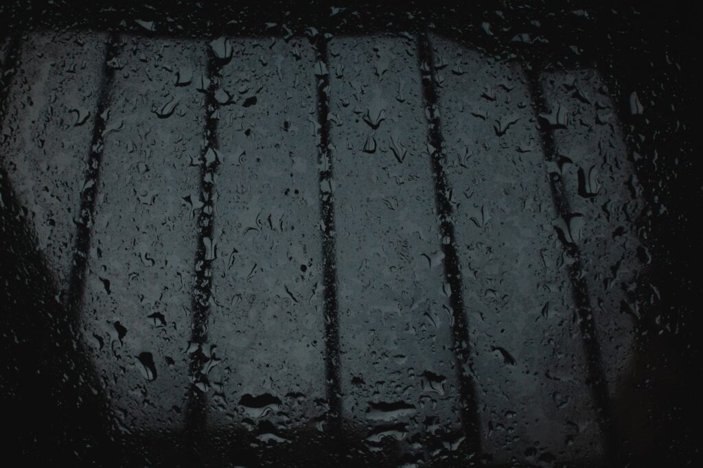 Close-up of rain droplets on a windowpane, creating a moody atmosphere, an image for Your Doubts Are Not a Disease